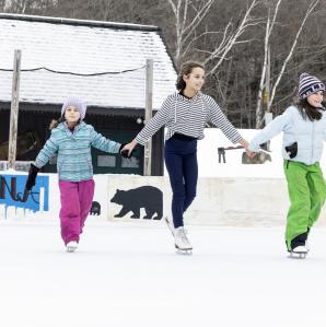 three girls ice skating