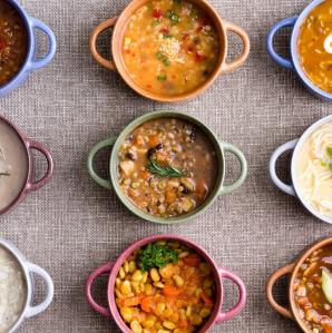 a photo of 9 different colored soup bowls with a different soup simetrically placed in rows