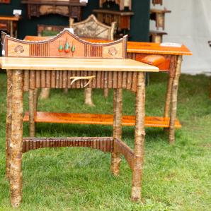 Several different end tables made from wood, twigs, branches and other rustic materials