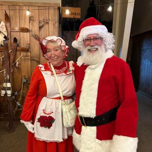 A couple dressed up as Mr & Mrs Clause