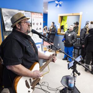 a man performing live music at the Indian Lake Welcome center