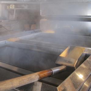 Maple syrup boilers steaming with hot sap