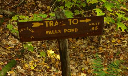 A sign pointing to Falls Pond