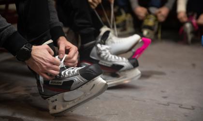 People tying their ice skates