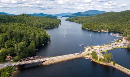 A causeway and road going across a long, narrow lake