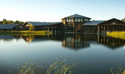 View of The Wild Center sitting across a shimmering body of water