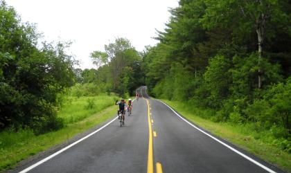 A couple bikers on a newly paved road