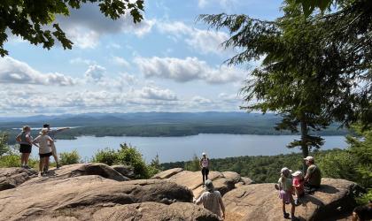 People at an overlook on a cliff with a view of the water