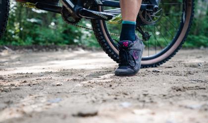 A close up of a bicycle wheel and foot