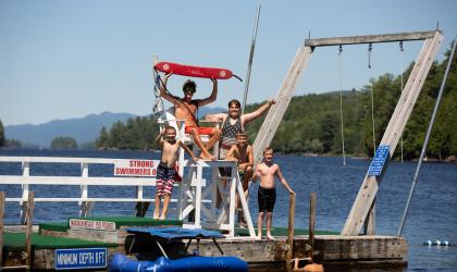 Some kids with a lifeguard on a floating dock in Long Lake.