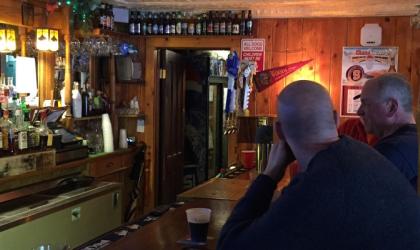 Two men sit at the bar.