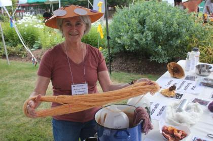 a woman holds yarn made from mushrooms