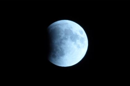 The moon up close&#44; reflecting the sun's light with a black sky behind it