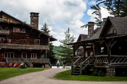 A picture of two buildings of Camp Sagamore in the great Adirondack camp style