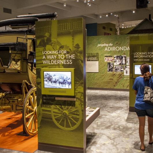 A woman walks through an Adirondack museum.