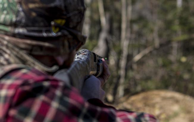 A man aims a rifle.