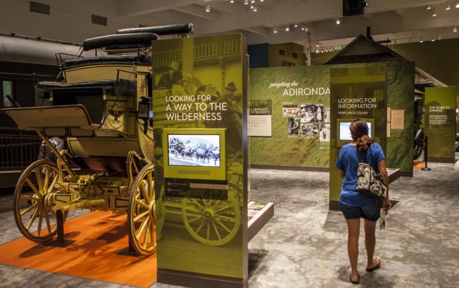 A woman walks through an Adirondack museum.