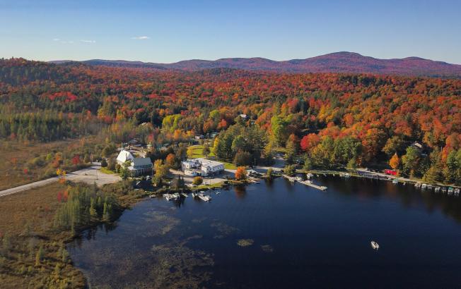 An aerial view of mountains and valley in fall.