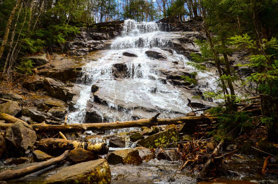 A waterfall tumbles over rocks and jagged streams.