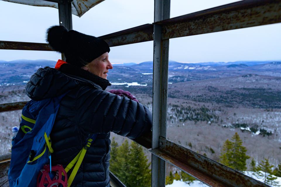 A woman in a firetower during winter