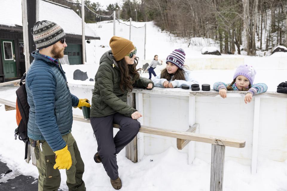 Kids and their parents at an outdoor ice skating rink