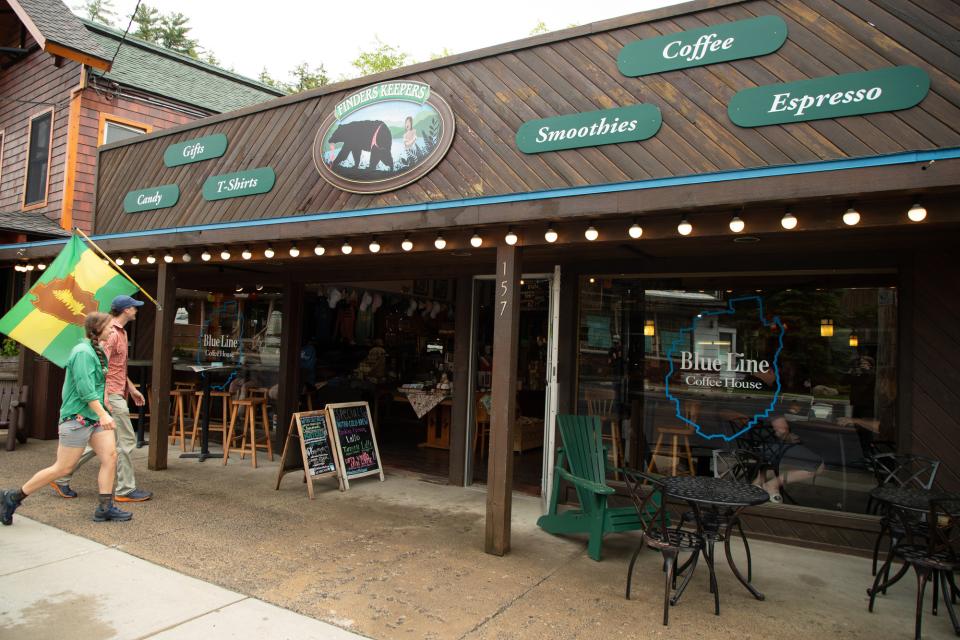 A man and woman walk into Blue Line Coffee.