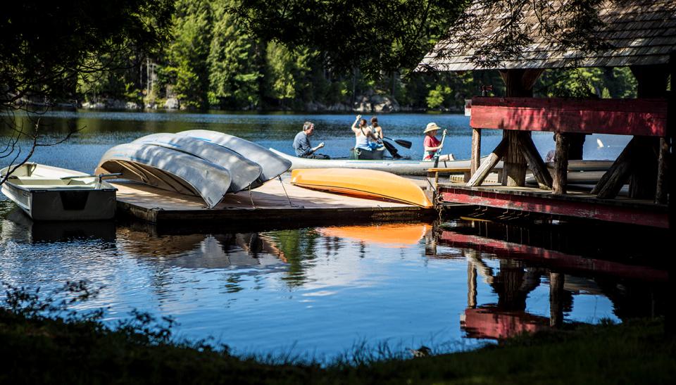 people get ready to canoe off the dock.