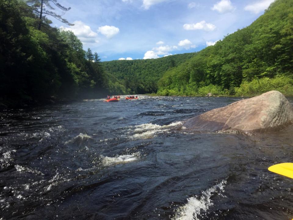 A couple of rafts exit a set of rapids.