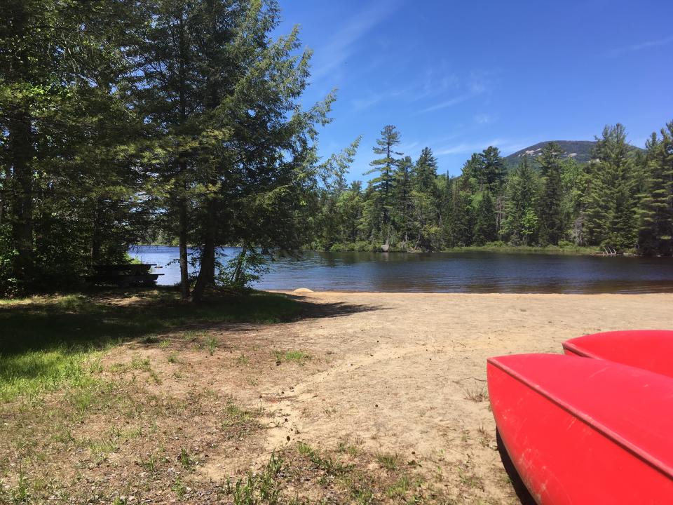 Canoes at the ready on the beach of Lake Durant.