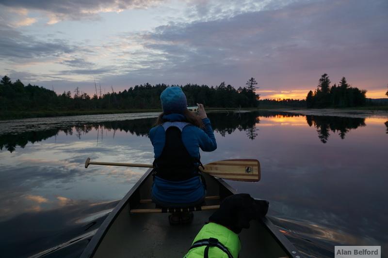 Wren and my friend enjoy the sunset along the channel into Round Lake.