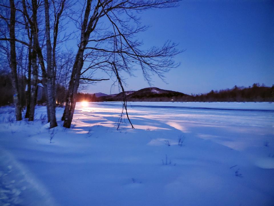 Snowmobiles by the River