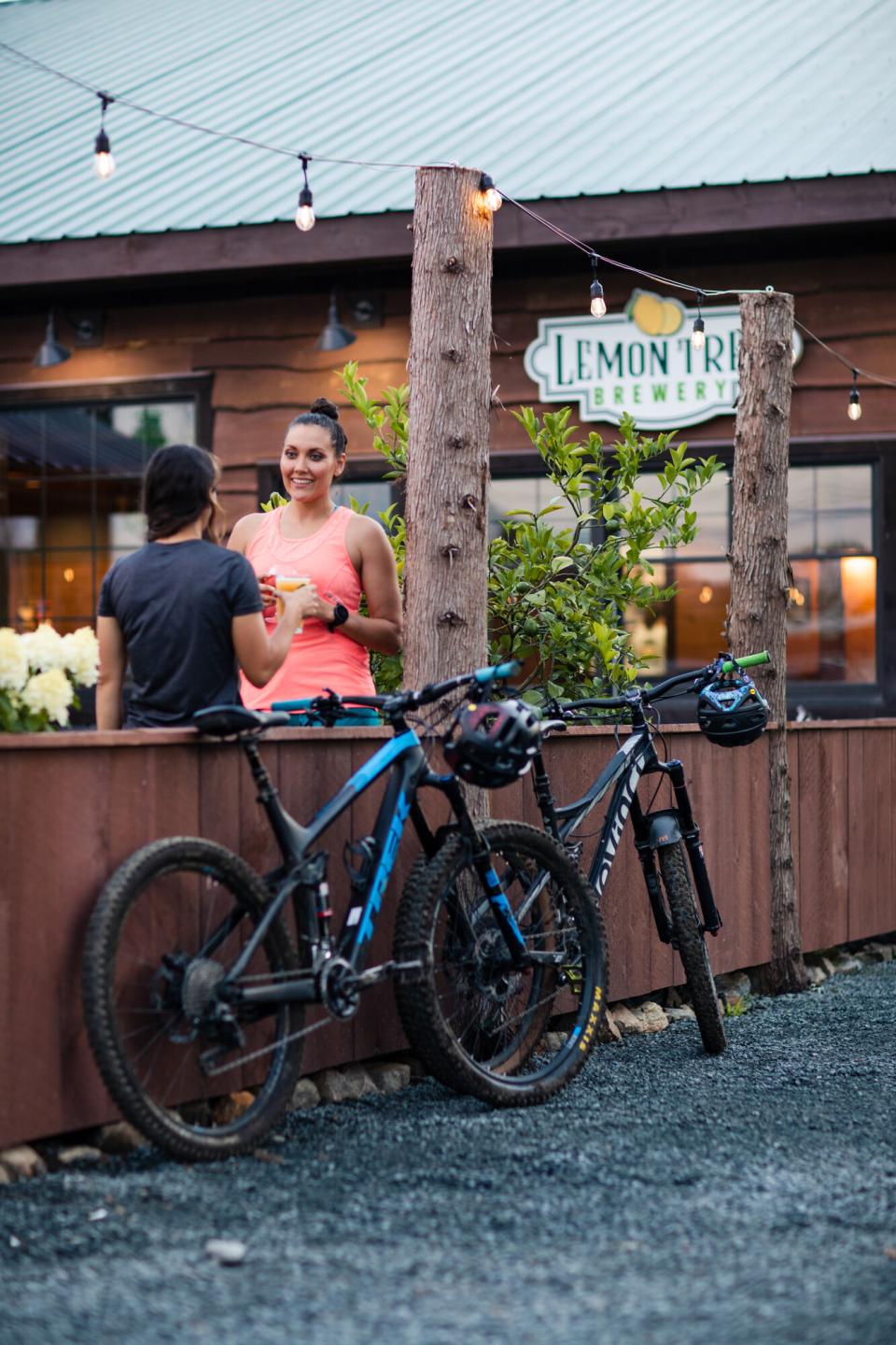 The author and another woman enjoy a drink on the outside patio of the Lemon Tree Brewery