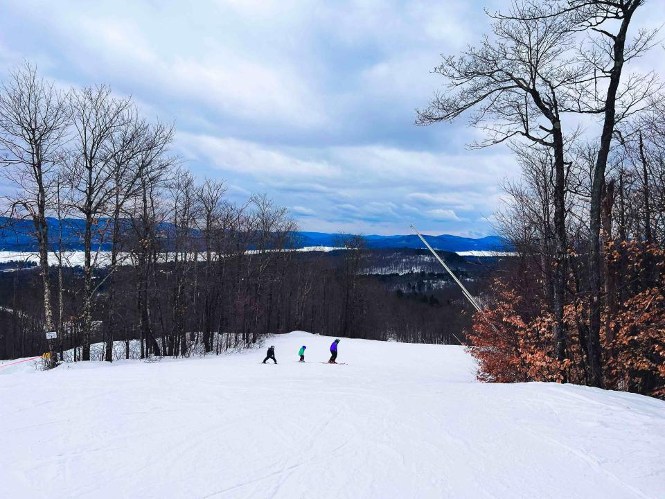 A ski lesson with young children heads down the mountain