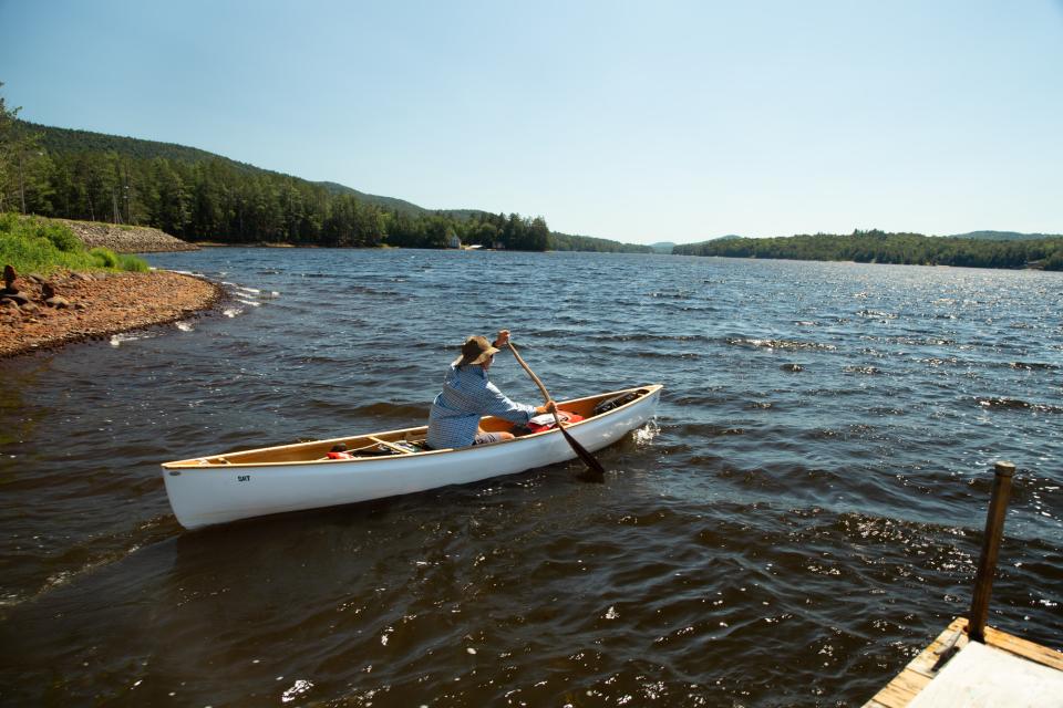 A man paddles off the shore in Long Lake.