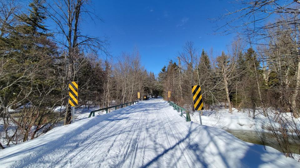 A snow-covered bridge over the Miami River.