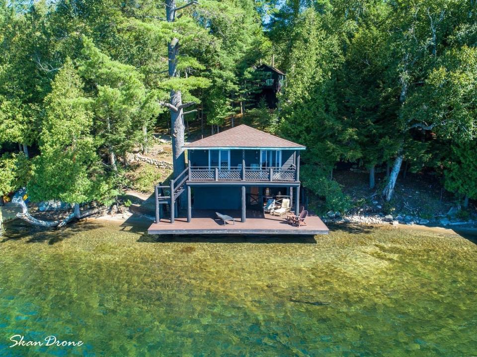 A lake house looks out at the water.