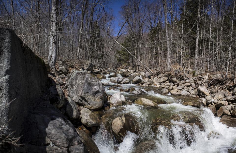 A large flow of water over small rocks