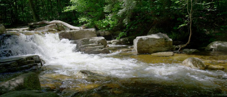 A smaller waterfall cascading over blocky rocks