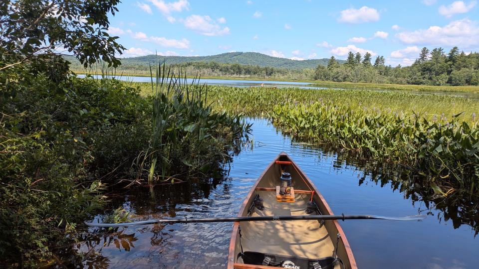 Canoe in a narrow channel looking out at Kunjamuk Bay.