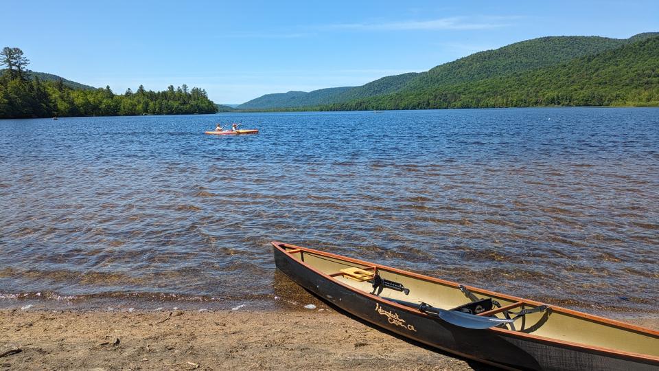 Canoe on the beach looking across Lewey Lake