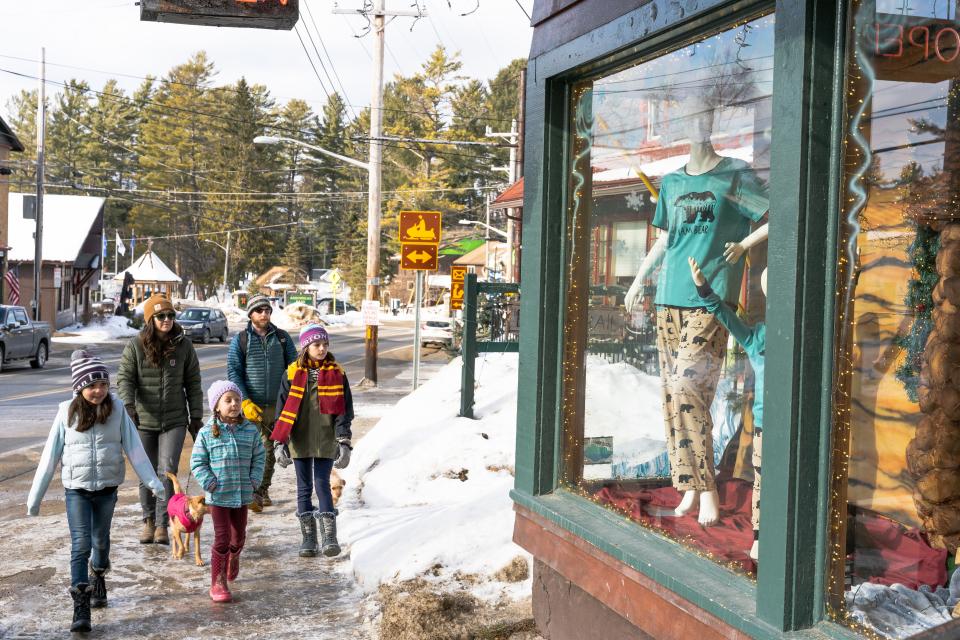 A family walking Main Street in Inlet.