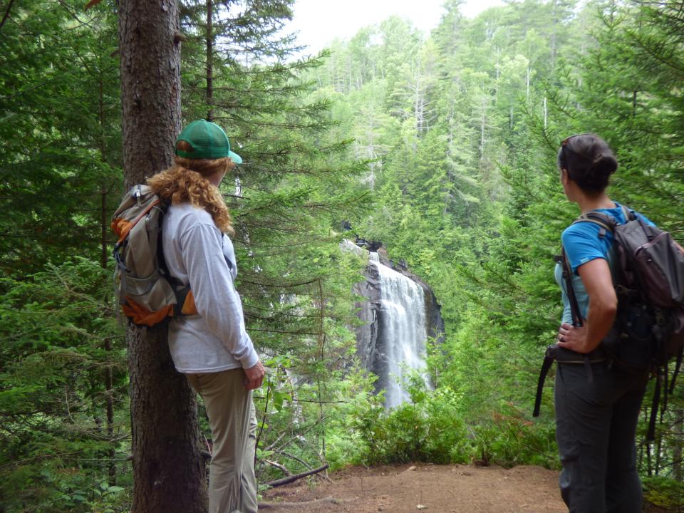 Two hikers looking at OK Slip Falls.