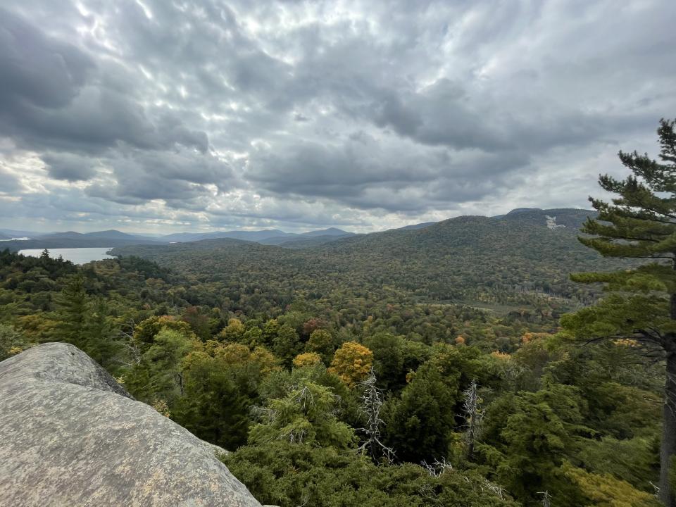 A hiker on the summit of Watch Hill in Indian Lake.