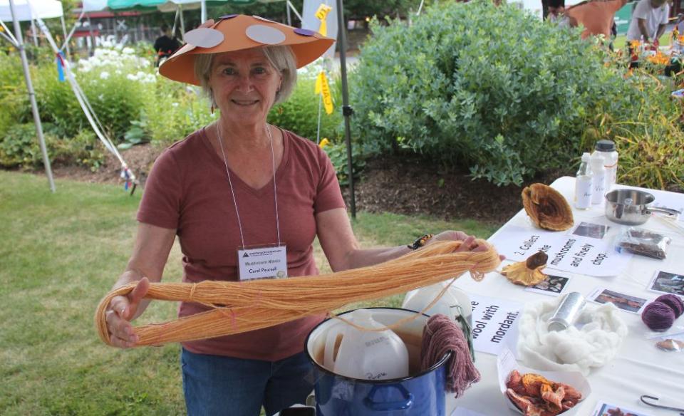 a woman holds yarn made from mushrooms