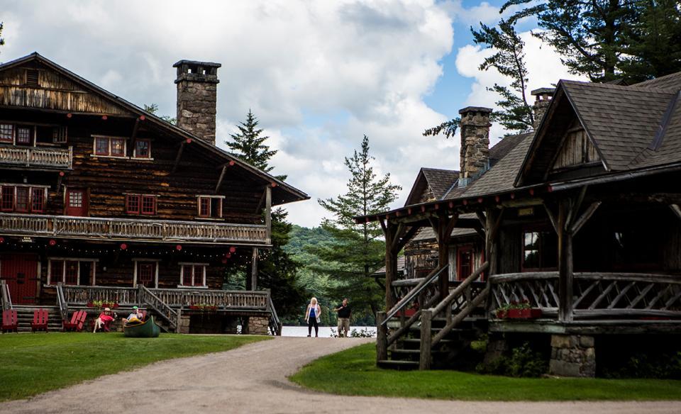 A picture of two buildings of Camp Sagamore in the great Adirondack camp style