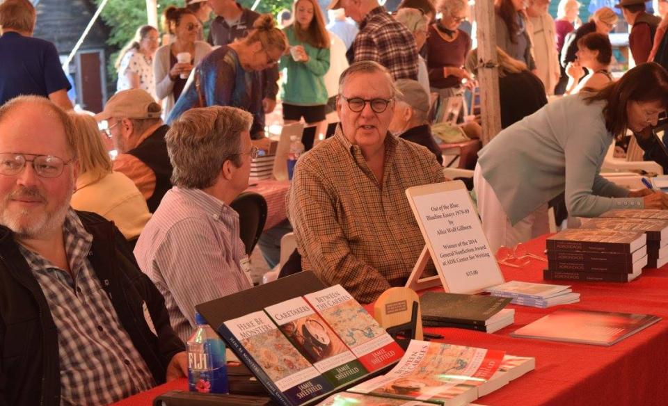 Photograph of people gathered under a large tent