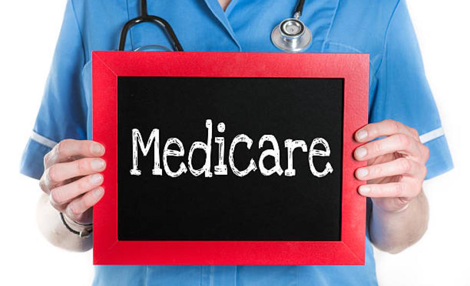 medical-person-holding-up-a-sign-that-reads-medicare