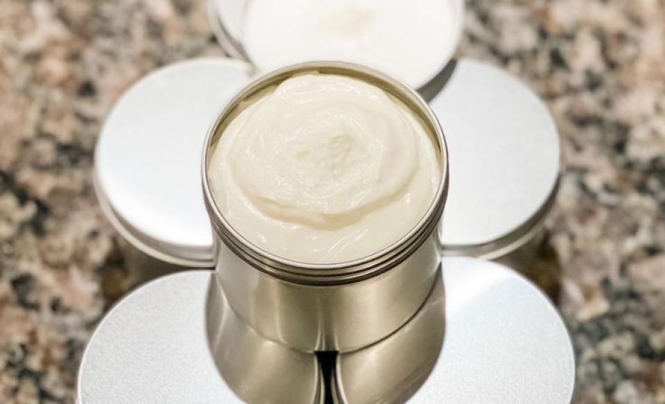 A photo of a small container with home-made lotion in it