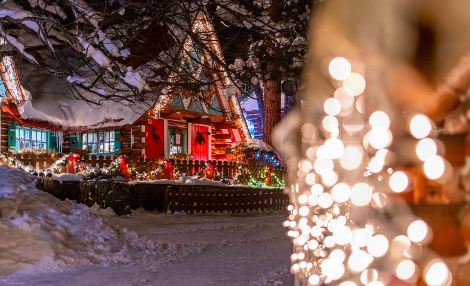 A photo of a home decorated with lights for the holidays