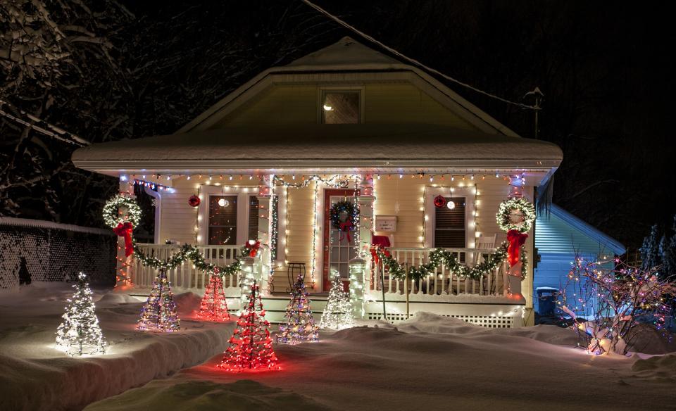 A home decorated with lights and outside decorations for Christmas